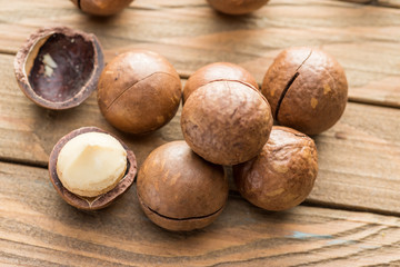 Macadamia nuts or bush nuts on the wooden table.