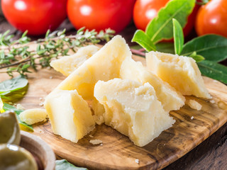 Parmesan cheese on wooden cutting board. Food background. © volff