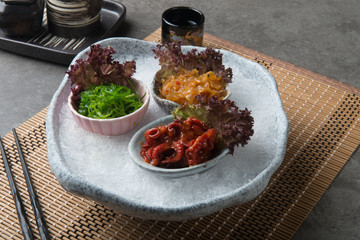 Japanese seasoned baby octopus, seaweed and jellyfish on shaved ice