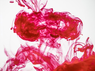 Deteiled photo of red coloured silky cloud isolated on white background. Red ink abstract background. Red acrylic ink mixing with water close up. Paint mixing with water close up, background