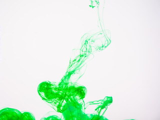 Green acrylic paint swirling under water. Image of green coloured acrylic swirl in liquid. Movement of green acrylic swirl, an abstract banner. Ink color dissipation in water