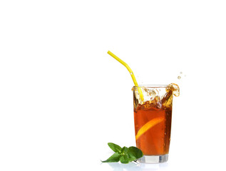 Splashes from a glass of cold tea with lemon.