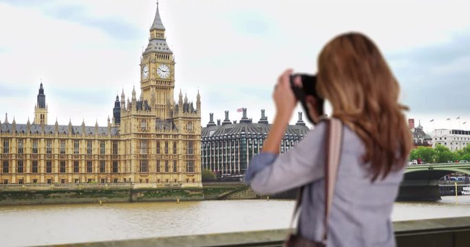 Rear view of travel photographer taking picture of Big Ben clock tower, Woman tourist photographing historic landmark in London, 4k