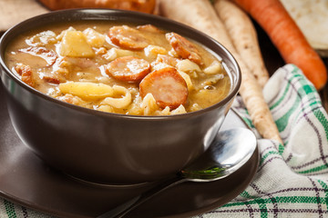 Traditional Polish split pea soup with sausage, bacon and potatoes