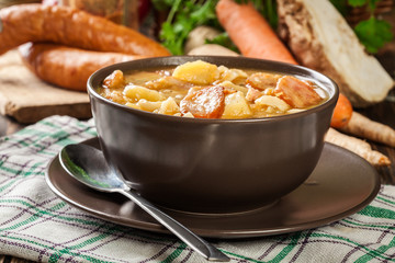 Traditional Polish split pea soup with sausage, bacon and potatoes