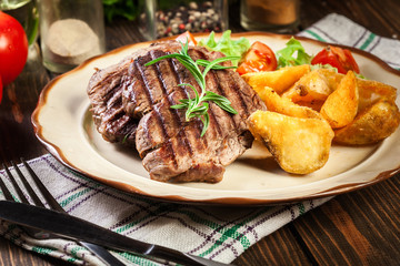 Succulent portions of grilled fillet mignon served with baked potatoes