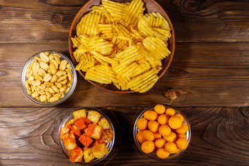 Mix of snacks for beer on wooden table