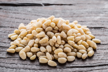 Group of pine nuts on the wooden table. Organic food.