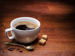 Cup of coffee on the wooden table.