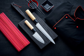 Asian kitchen chef accessories on black stone table - obrazy, fototapety, plakaty