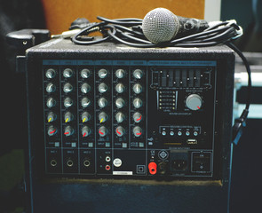 Panel of sound mixer with microphone. Vintage colour.