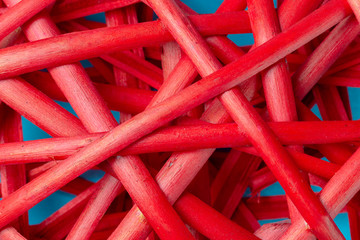Texture or background of braided red straw on blue background