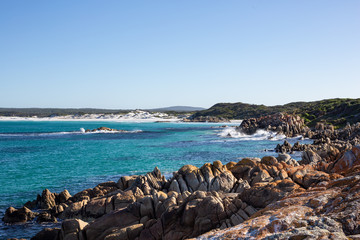 Fototapeta na wymiar White sand and waves at The Bay of Fires, Tasmania, Australia