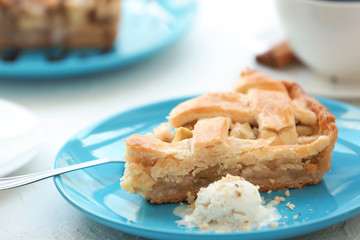 Plate with piece of tasty apple pie and ice-cream on table, closeup