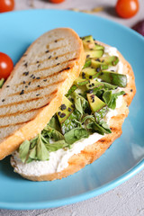Delicious toast with avocado on plate, closeup