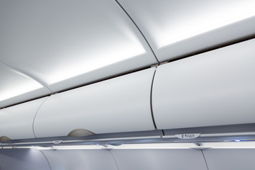 Luggage shelf in an airplane. Aircraft interior. Travel concept.