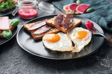 Plate with toasted bread and eggs on textured table