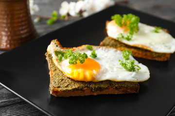 Plate with toasted bread and egg on table, closeup