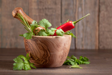 Warious herbs on a old wooden table .