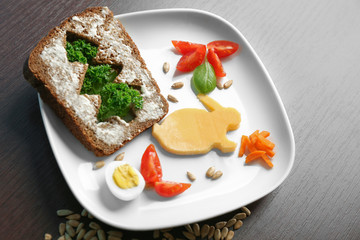 Plate with creative toast for child on table