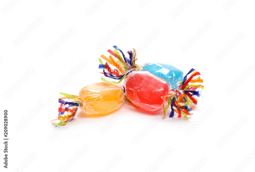 Wall mural colorful candies with transparent cellophane wrapping isolated on white background