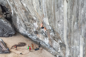 A group of climbers climb a cliff