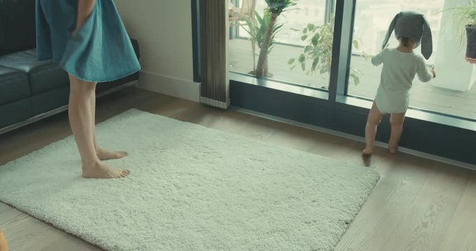 Mother and child by window in city apartment