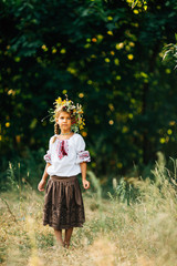 Portrait of a girl in an embroidered wreath and a wreath of viburnum