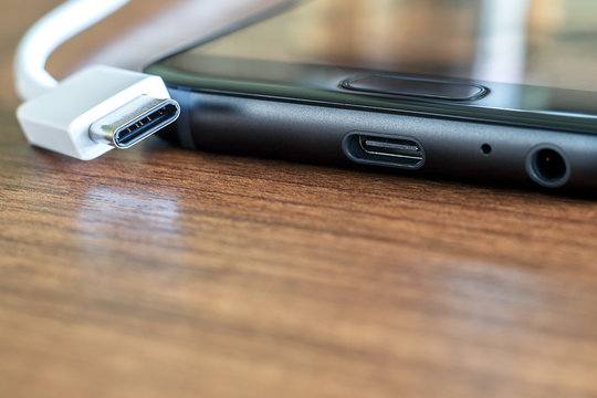 New fast USB Type-C port on mobile phone and cable close-up
