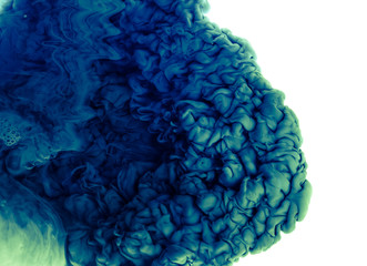 Color drop in water, photographed in motion. Abstract swirling. Cloud of silky bulb under water...