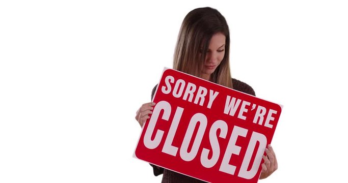 Caucasian Woman holding Closed sign standing on solid white background, Female in her 20s looking at camera with sign saying Sorry We Are Closed on white copy space, 4k