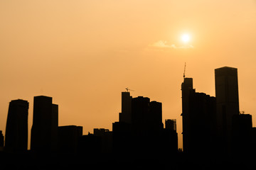 Naklejka na ściany i meble Silhouette of the city at sunset