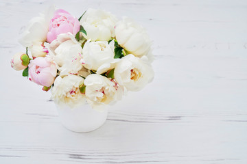 White peonies in the white flower pot. Flowers background. Top view, copy space