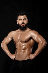 Fototapeta na wymiar Handsome strong bodybuilder posing