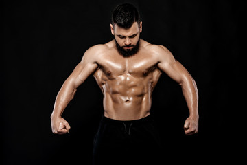 Fototapeta na wymiar Handsome strong bodybuilder posing