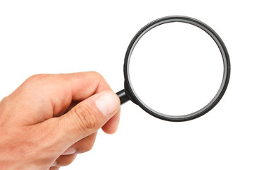 Man's hand with magnifying glass.