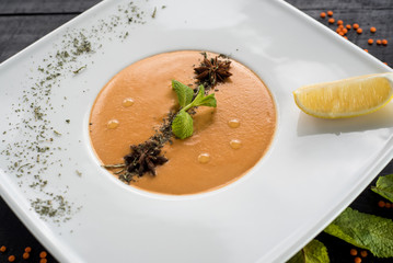 Lentils cream soup on wooden background