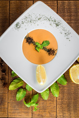 Lentils cream soup on wooden background