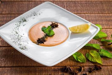Lentils cream soup on wooden background