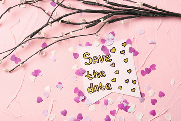 Composition with "Save the date" card on color background
