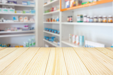 Pharmacy drugstore counter table with blur abstract backbround with medicine and healthcare product on shelves