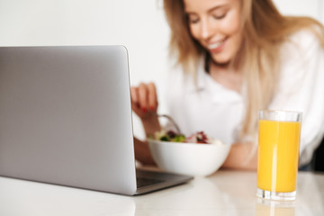 Close up of happy woman eating salad