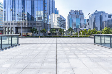 Panoramic skyline and modern business office buildings with empty road,empty concrete square floor