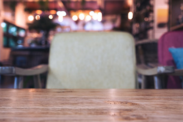 Wooden table and chair in cafe with blur bokeh background