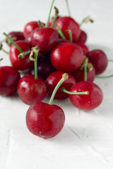 ripe cherries on white textured background