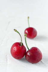 ripe cherries on white textured background
