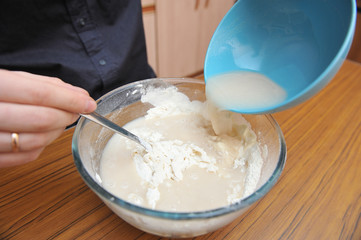 Prepare the dough for homemade pizza, hand knead the dough with yeast