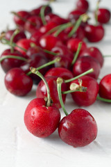 ripe cherries on white textured background