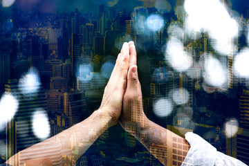 Double exposure of people hand assembly high five for good teamwork,Business success Team in the city background
