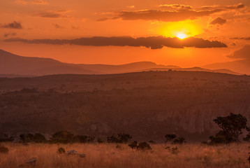 A golden orange sunset over the hills and savannah at Blyde River Canyon in Mpumalanga, South Africa